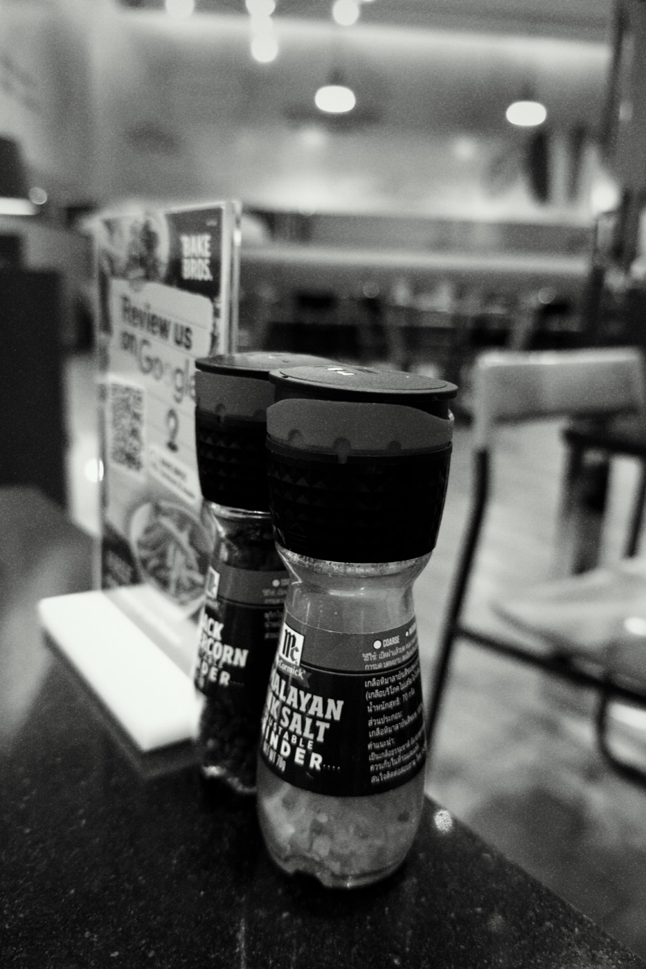 Salt and pepper grinders on a cafe table — Hi-Contrast B&W recipe